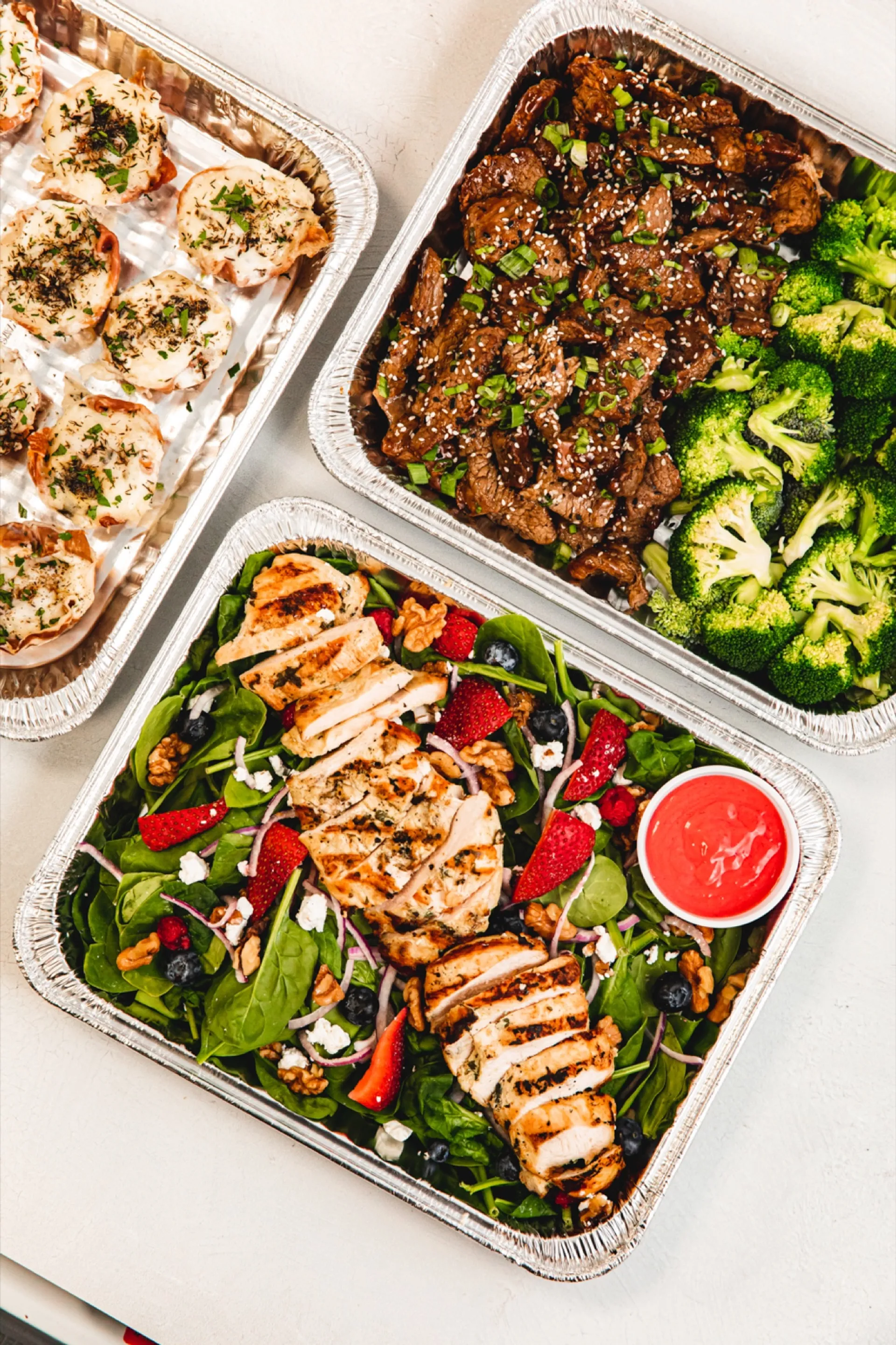 Family-style catering package from Deli Nerds with mains, sides, and dessert